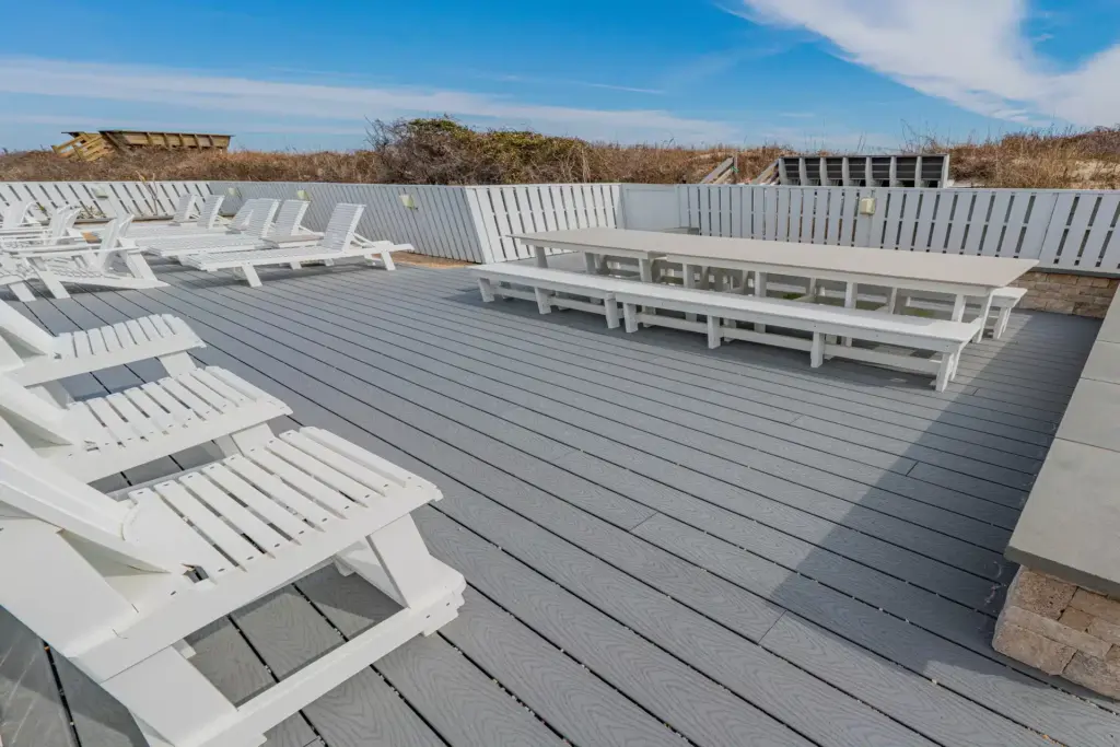 commercial-deck-with-bench-and-multiple-lounge-featuring-white-privacy-fence-in-outer-banks-nc