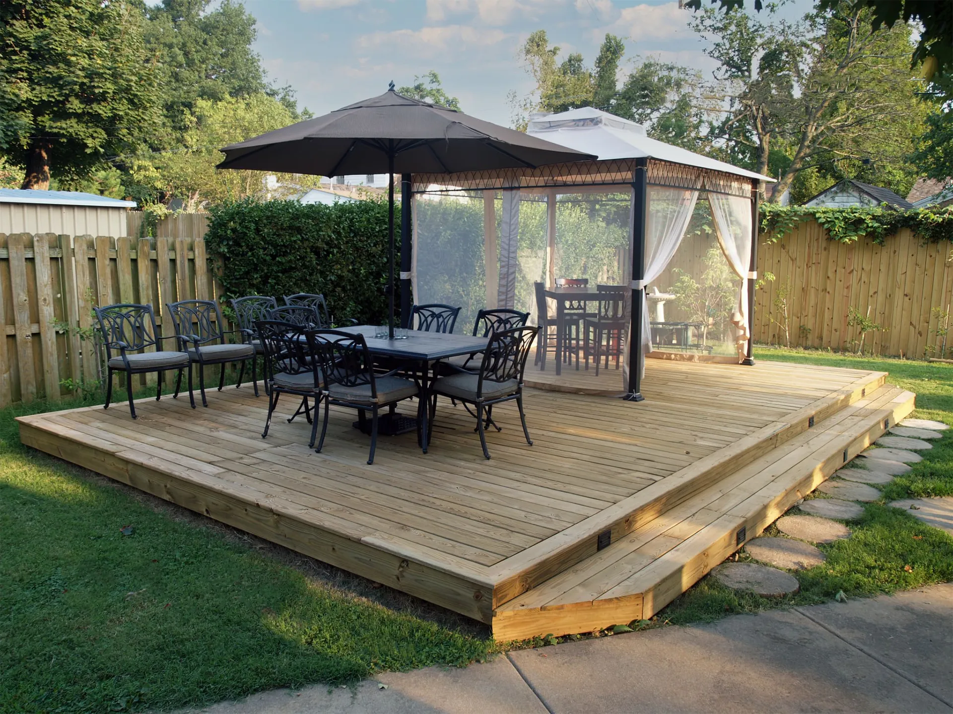 custom-backyard-residential-deck-with-cabana-and-outdoor-living-dining-set-area-featuring-wooden-wall-fence-in-outer-banks-nc