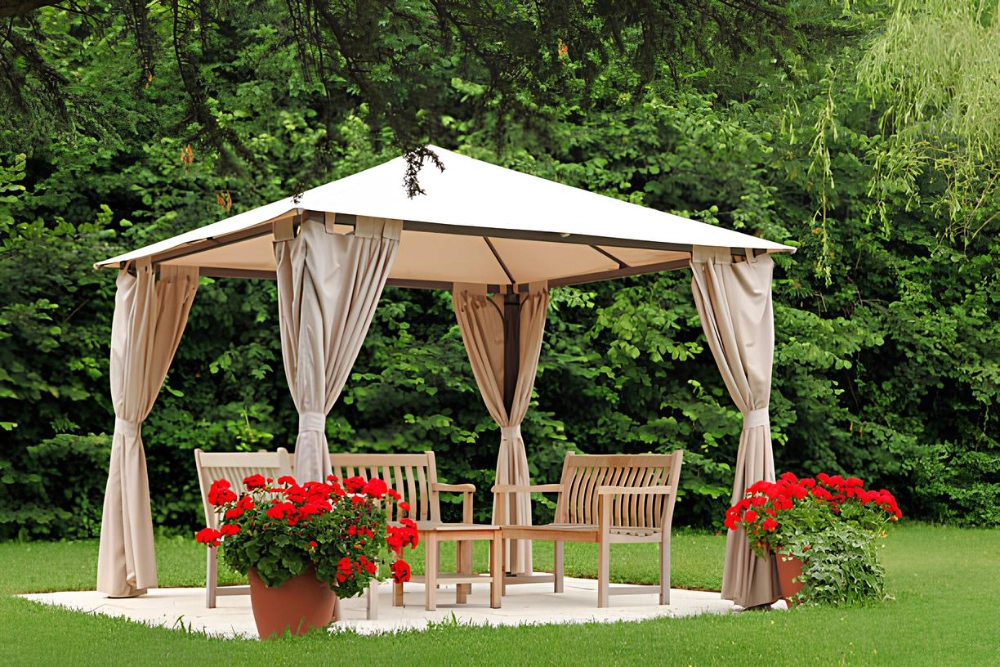 gable-pergola-with-wooden-chairs-and-potted-plants-decoration-surrounded-by-grass-and-trees-on-the-background-in-outer-banks-nc