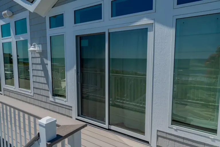 glass-sliding-door-replacement-on-the-residential-gray-house-with-residential-deck-in-outer-banks-nc