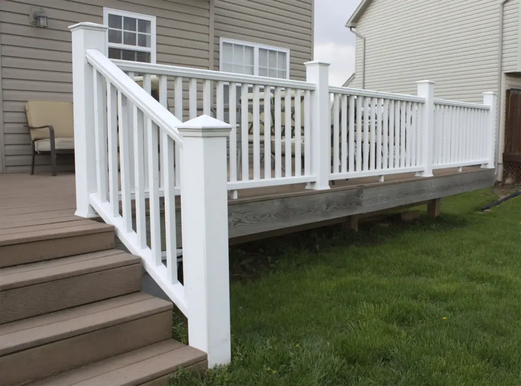 raised-wooden-deck-with-white-railings-and-outdoor-living-area-in-outer-banks-nc