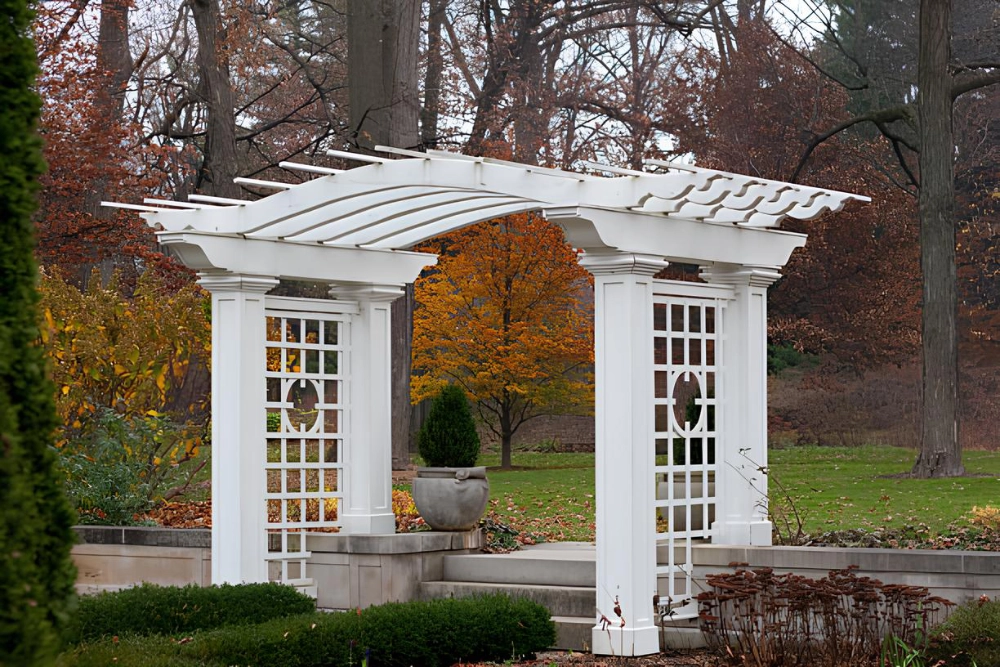 white-arched-pergola-on-the-forest-walkway-surrounded-by-beautiful-and-colorful-plants-and-trees-in-outer-banks-nc