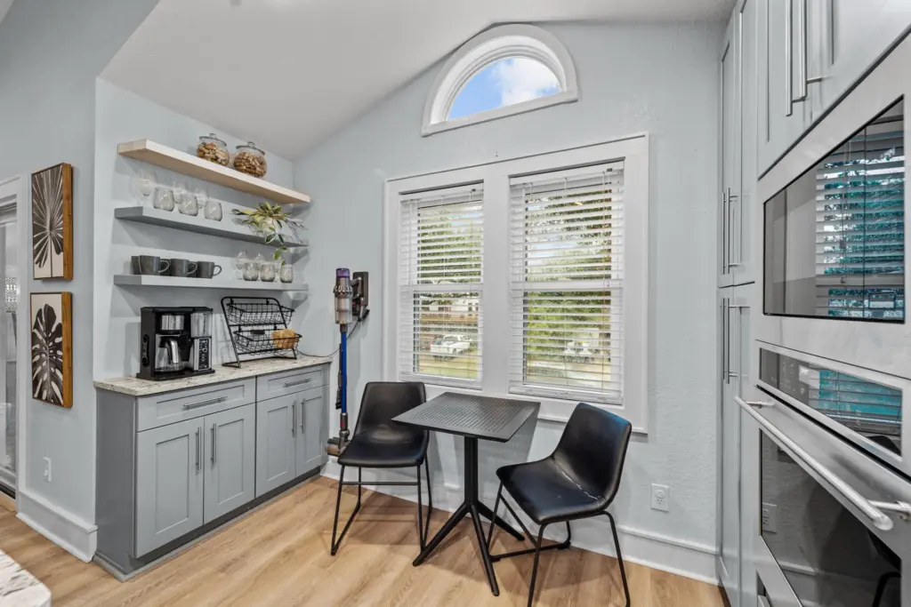 white-trim-window-replacement-on-the-beautiful-house-with-black-chairs-and-table-and-decorations-in-outer-banks-nc